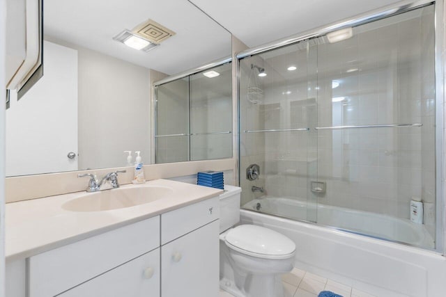 full bathroom featuring vanity, toilet, tile patterned flooring, and enclosed tub / shower combo