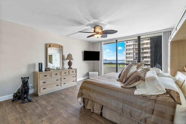 bedroom with dark wood-type flooring, floor to ceiling windows, and ceiling fan