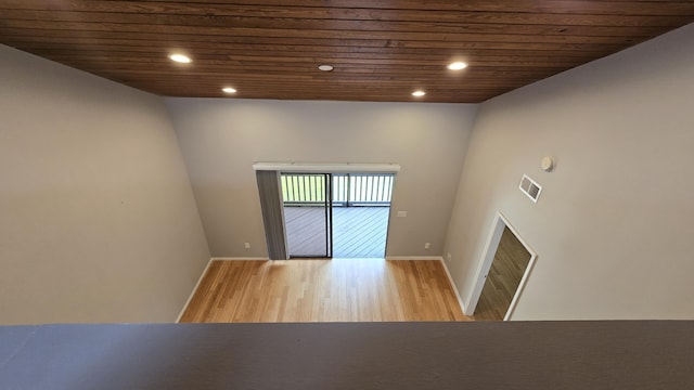 spare room featuring hardwood / wood-style floors and wood ceiling