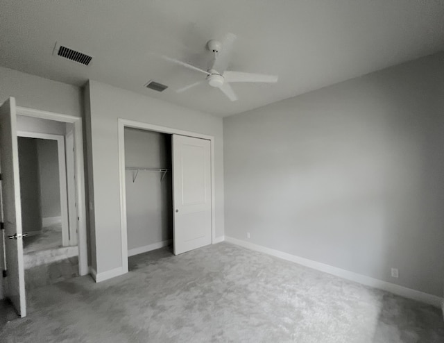 unfurnished bedroom with carpet flooring, ceiling fan, and a closet