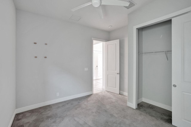 unfurnished bedroom with ceiling fan, a closet, and light colored carpet