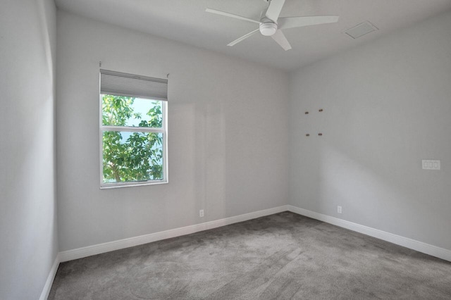 carpeted spare room featuring ceiling fan