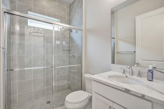 bathroom featuring vanity, toilet, and walk in shower