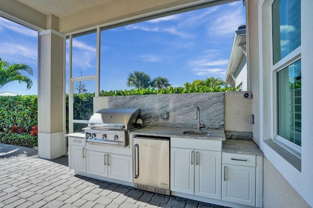 view of patio featuring area for grilling, grilling area, and sink