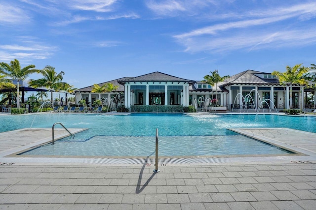 view of pool featuring pool water feature and a patio