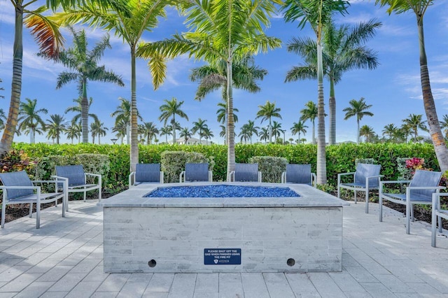 view of home's community with a patio area and an outdoor fire pit