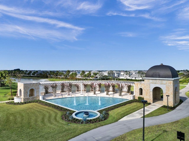 view of swimming pool featuring a lawn