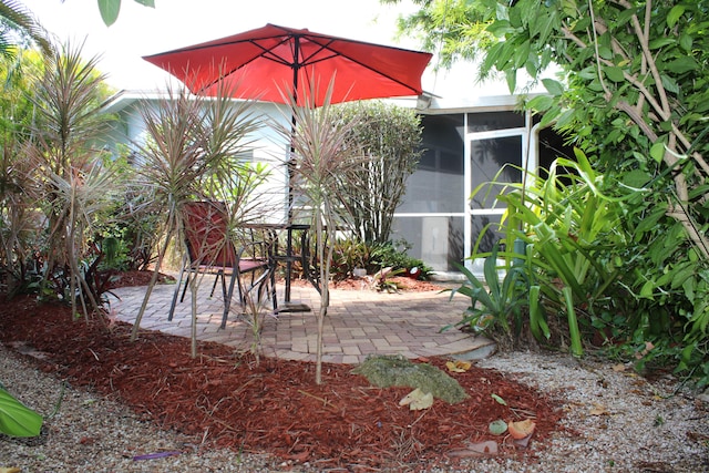 view of patio featuring a sunroom