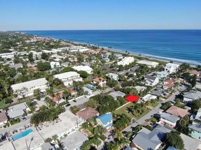 aerial view featuring a water view and a beach view