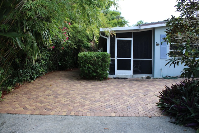 view of patio / terrace featuring a sunroom