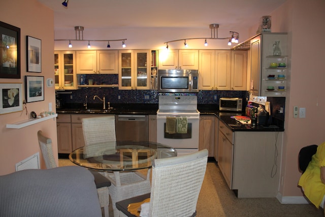 kitchen featuring decorative backsplash, sink, and stainless steel appliances