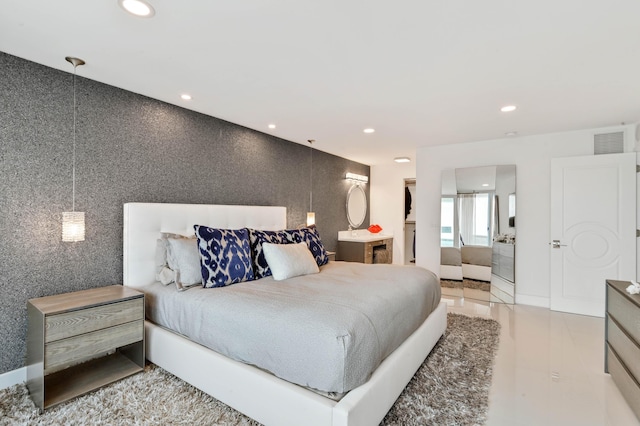 bedroom with ensuite bath, a walk in closet, and a closet