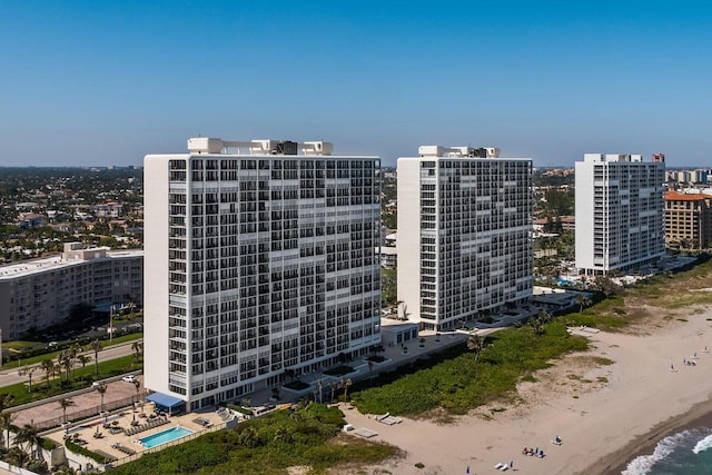 drone / aerial view with a water view and a beach view