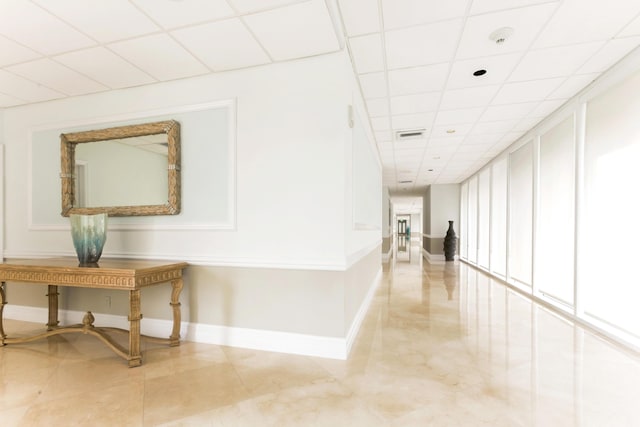 hallway featuring a drop ceiling