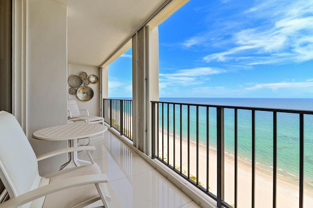 balcony with a water view and a beach view