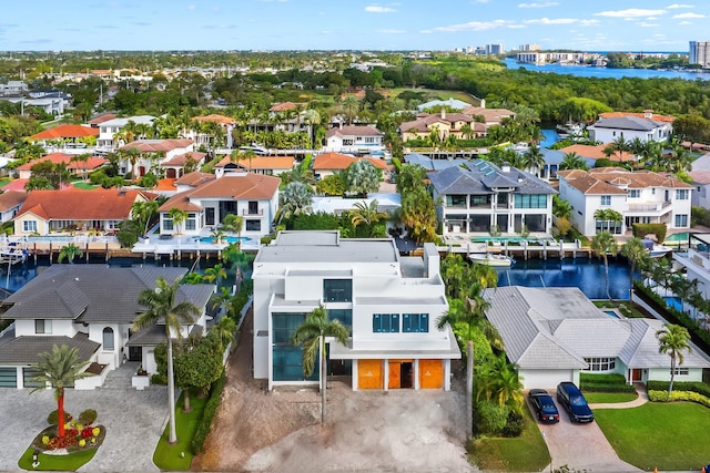 drone / aerial view featuring a residential view and a water view