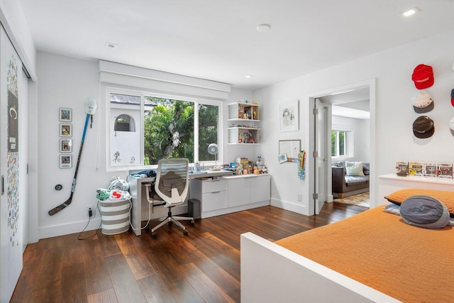 office with dark wood-type flooring and plenty of natural light