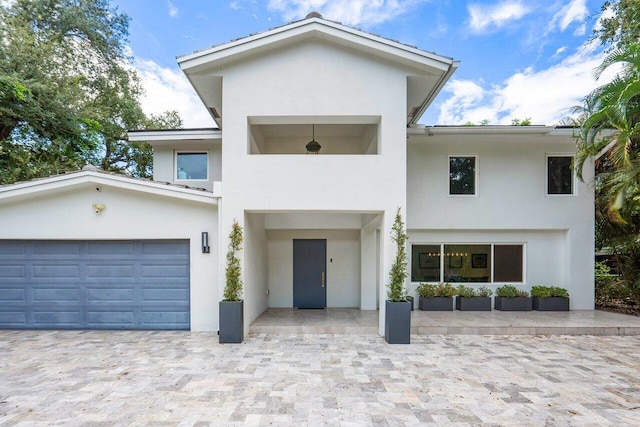 1145 SW 20th St, Boca Raton, FL 33486 - contemporary house featuring decorative driveway, a garage, and stucco siding