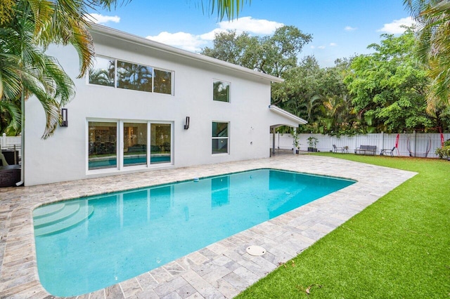 view of swimming pool with a yard and a patio