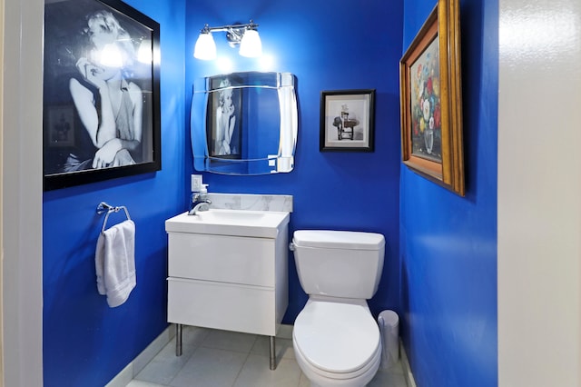 bathroom with vanity, tile patterned flooring, and toilet