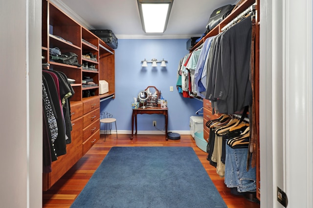 walk in closet with dark wood-type flooring