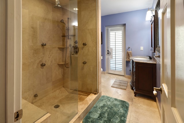 bathroom featuring a tile shower, tile patterned flooring, and vanity