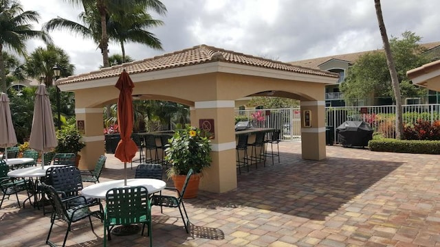 view of patio / terrace with a gazebo, area for grilling, and an outdoor bar