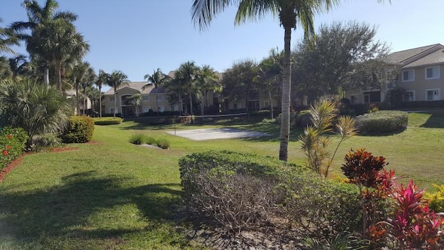 view of community with volleyball court and a yard