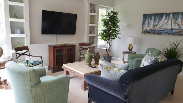 living room featuring built in features and light tile patterned floors