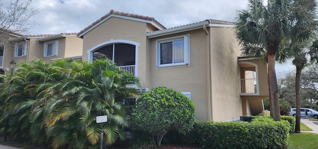 view of side of property featuring a balcony