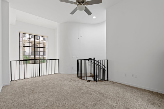 carpeted empty room featuring ceiling fan