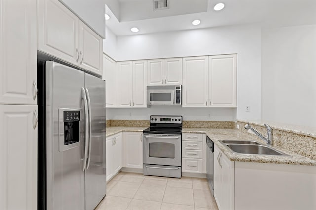 kitchen with white cabinetry, sink, light stone counters, light tile patterned floors, and appliances with stainless steel finishes