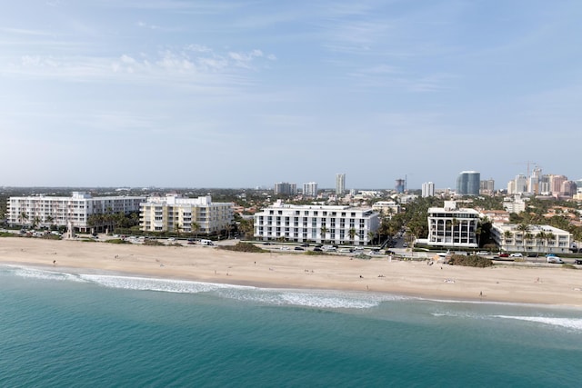 bird's eye view with a water view and a beach view