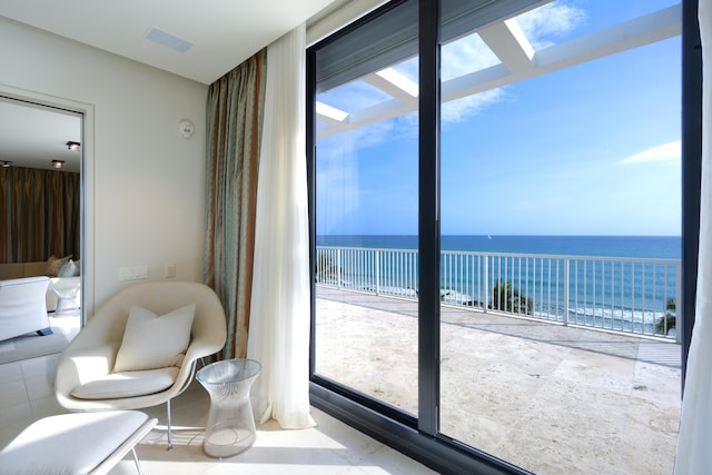 interior space featuring a skylight, a water view, and a wealth of natural light