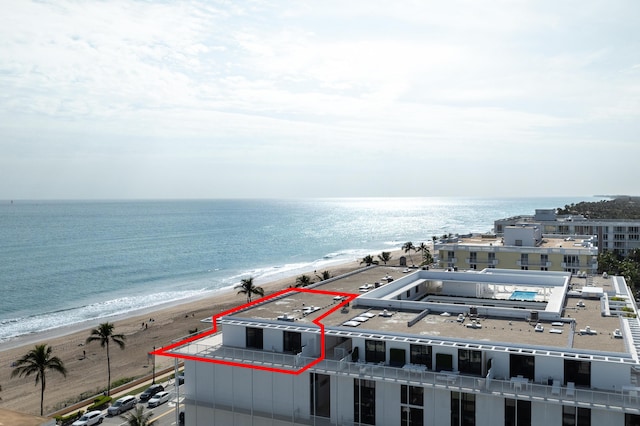 birds eye view of property with a water view and a view of the beach