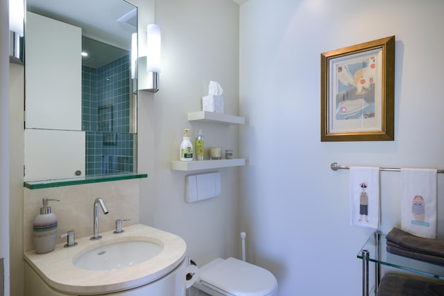 bathroom featuring toilet and vanity