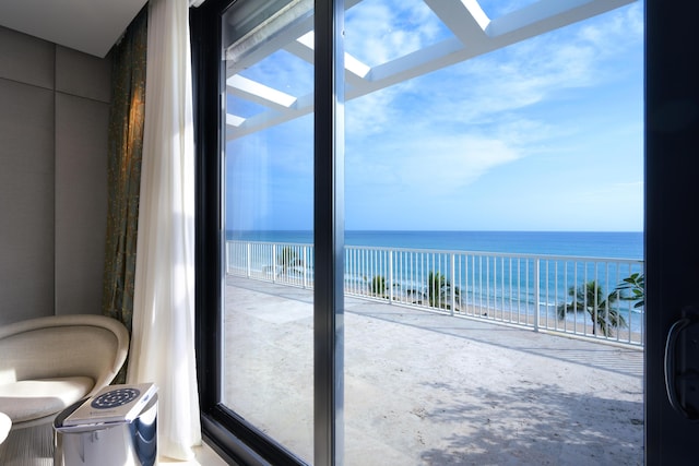 doorway with a water view and a beach view