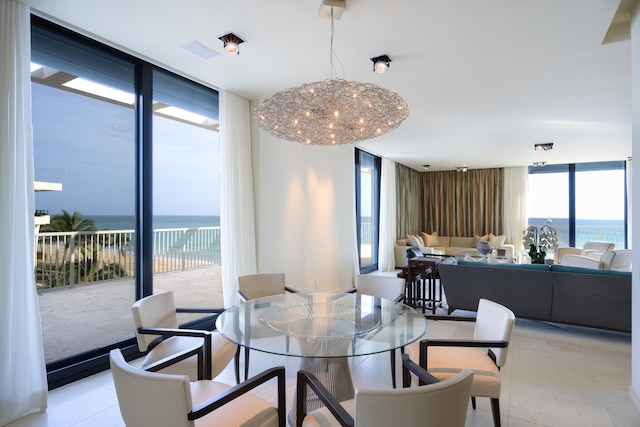 tiled dining space with a water view and expansive windows