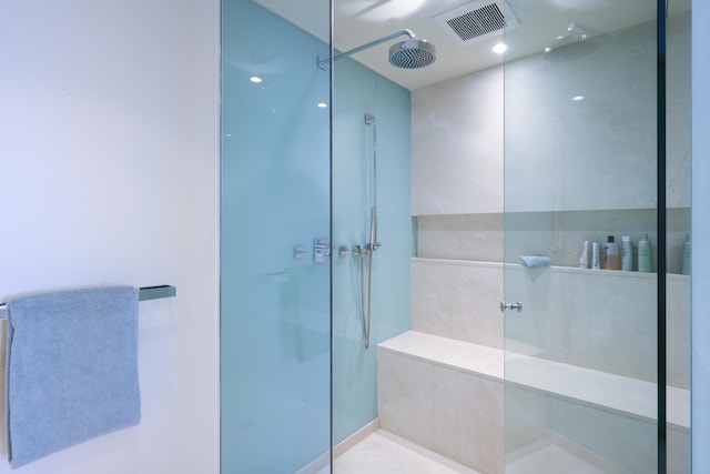 bathroom with a shower and tile patterned floors