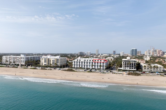 birds eye view of property with a beach view and a water view