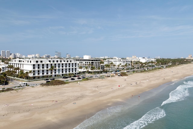 birds eye view of property with a water view and a view of the beach