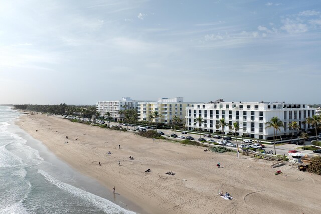 birds eye view of property with a view of the beach and a water view