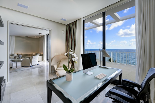 office featuring expansive windows and light tile patterned flooring