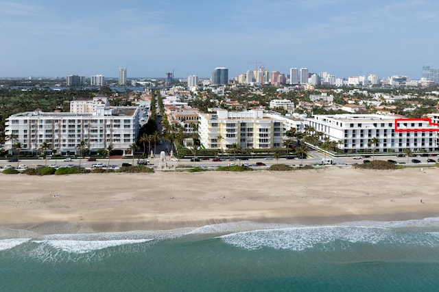 aerial view with a water view and a view of the beach