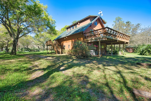 back of house with a wooden deck and a lawn