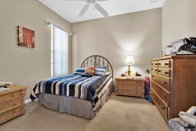 bedroom with light carpet and ceiling fan