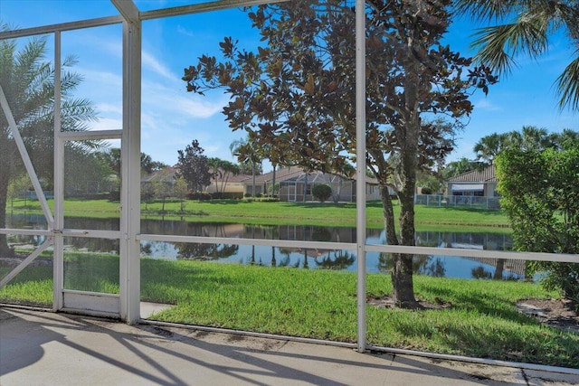 unfurnished sunroom featuring a water view