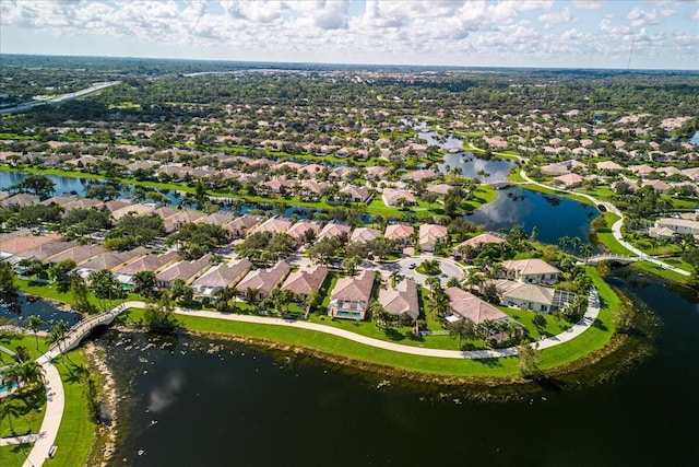 drone / aerial view featuring a water view and a residential view