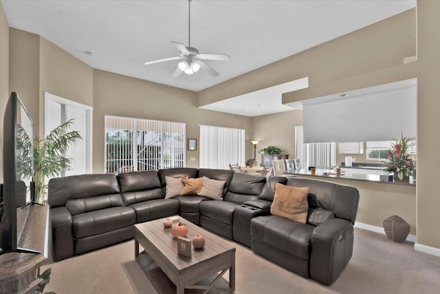 carpeted living room featuring plenty of natural light and ceiling fan