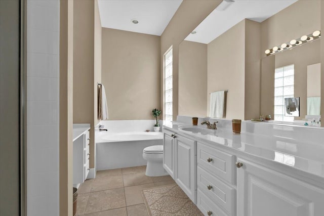 bathroom with toilet, a garden tub, tile patterned flooring, and vanity